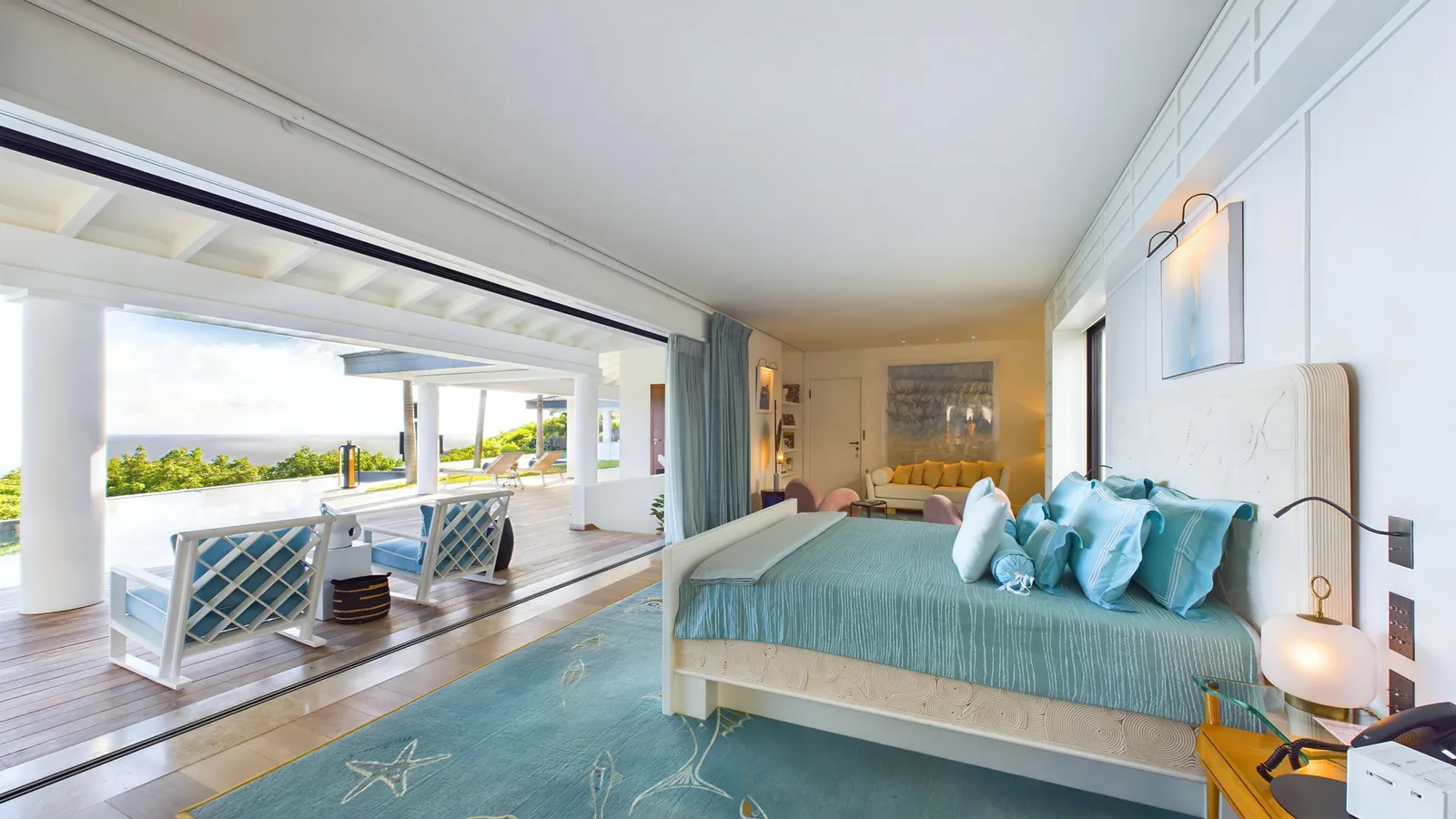 Indoor living area at Villa Amitie with television and air conditioning