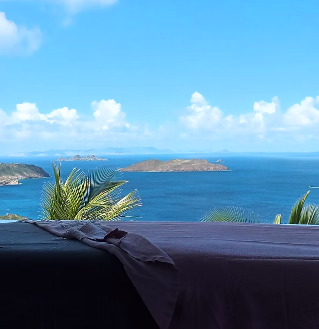 Open-air massage table set on a villa terrace overlooking the Caribbean in St Barth